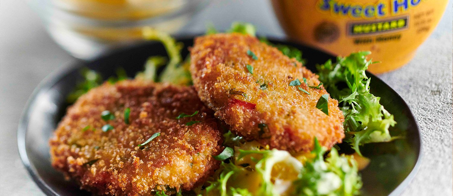 Crab cakes over salad with Inglehoffer Sweet Hot Mustard