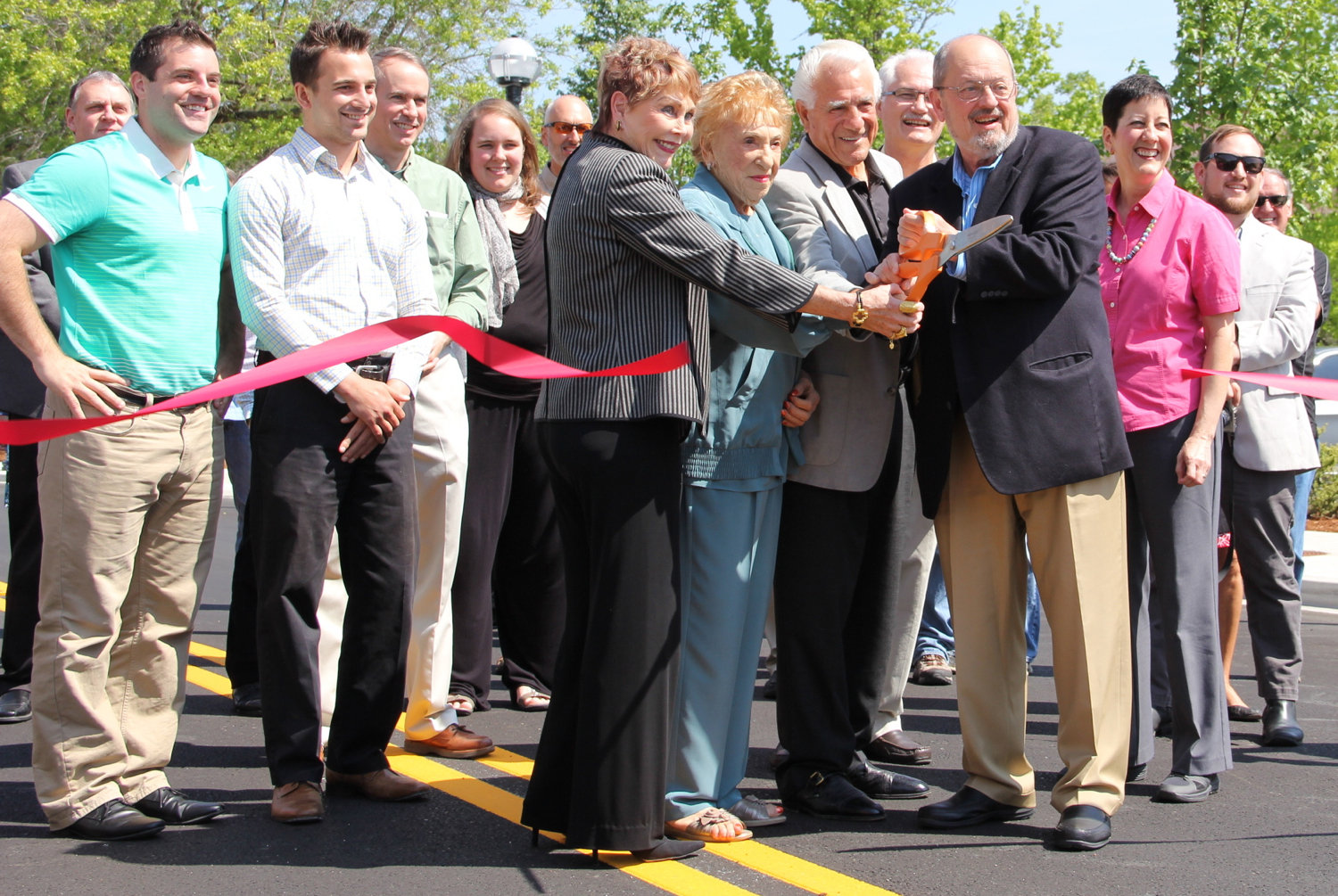 Geno Biggi, family, and guests cutting the ribbon to open Rose Biggi Avenue