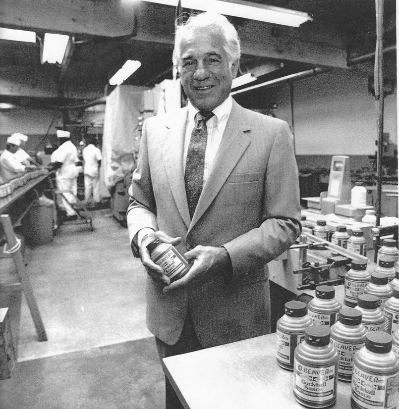 Geno Biggi holding a squeeze bottle of specialty mustard