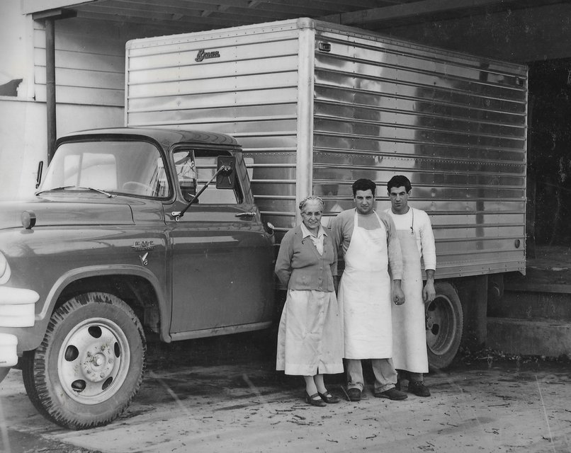 Rose Biggi and family members standing next to a delivery truck